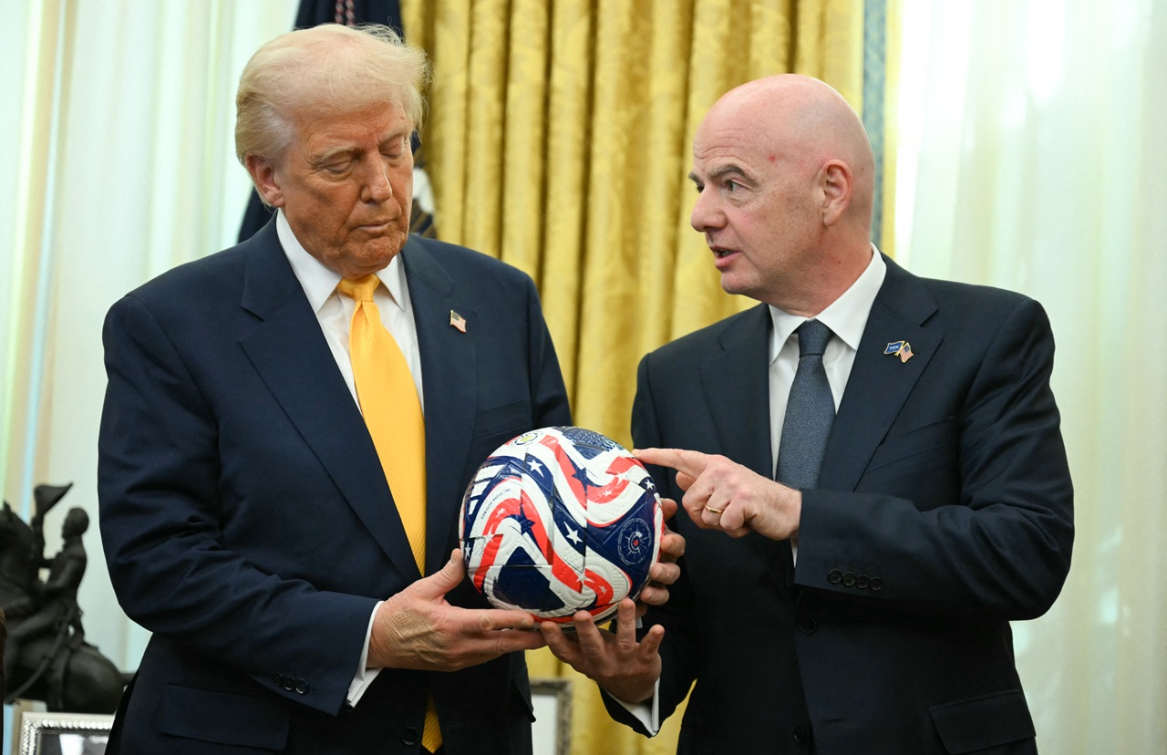 FIFA president Gianni Infantino presents US President Donald Trump with the new FIFA Club World Cup official ball in the Oval office of the White House, in Washington, DC, on March 7, 2025. (Photo by Jim WATSON / AFP)